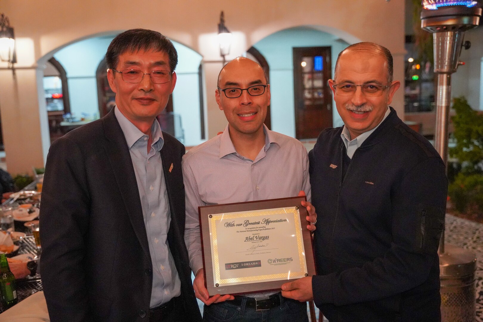 Carderock's Dr. Abel Vargas (center) is presented with a certificate of appreciation for his participation in the 2023 Manufacturing Expo from Dr. James Li (left), the Director of I-DREAM4D and Chair of the Manufacturing and Industrial Engineering, and Dr. Ala Qubbaj (right), University of Texas Rio Grande Valley Dean for the College of Engineering and Computer Science, in Edinburg, Texas, from Feb. 16-17. (Photo provided by Dr. Abel Vargas)