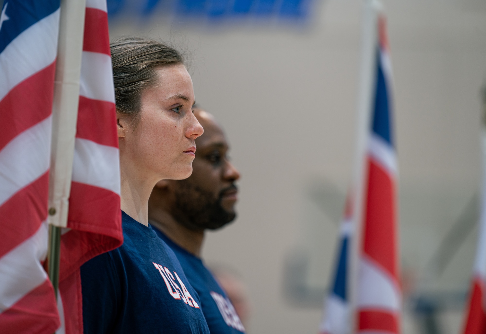 woman stands during national anthem