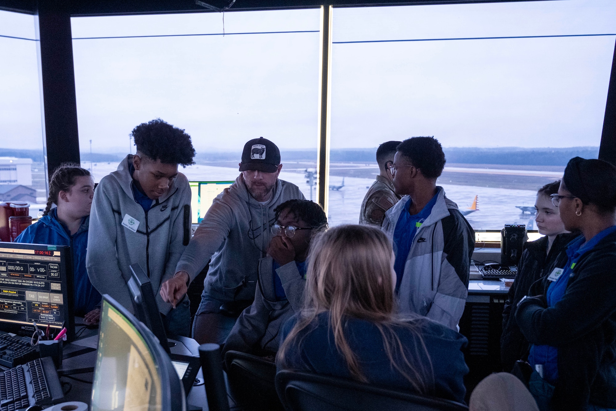 Students look at a computer screen during a tour of the air traffic control tower.