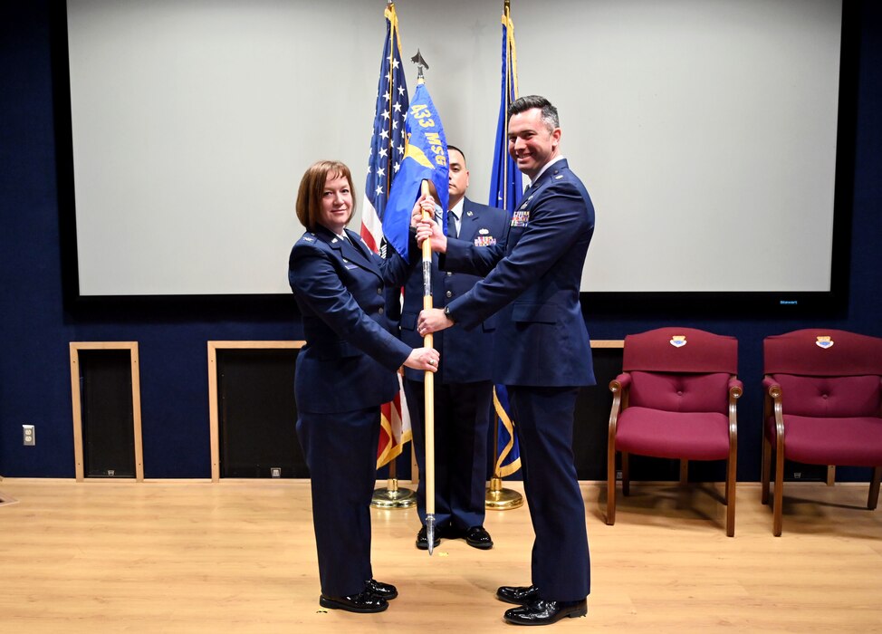 Col. Jeanne E. Bisesi, 433rd Mission Support Group commander, presents the 433rd Force Support Squadron guidon to Maj. Brian E. Hoffman during an assumption of command ceremony at Joint Base San Antonio-Lackland, Texas, March 4, 2023.