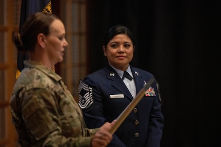 Senior Master Sgt. Virginia Holmgren, 124th Medical Group operational readiness superintendent, receives a Stripes for Exceptional Performers II Program promotion to chief master sergeant after seeing her oldest son, Nathan Holmgren, enlist in the Idaho Air National Guard the same day at Gowen Field, Boise, Idaho, March 4, 2023. Holmgren has spent her career with the critical care air transport team as a respiratory therapist.