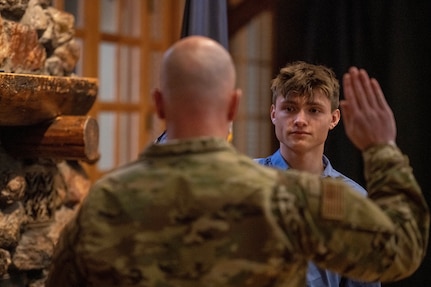 Nathan Holmgren, the eldest son of Senior Master Sgt. Virginia Holmgren, 124th Medical Group operational readiness superintendent, enlists in the Idaho Air National Guard on the same day his mother receives a Stripes for Exceptional Performers II Program promotion to chief master sergeant at Gowen Field, Boise, Idaho, March 4, 2023.