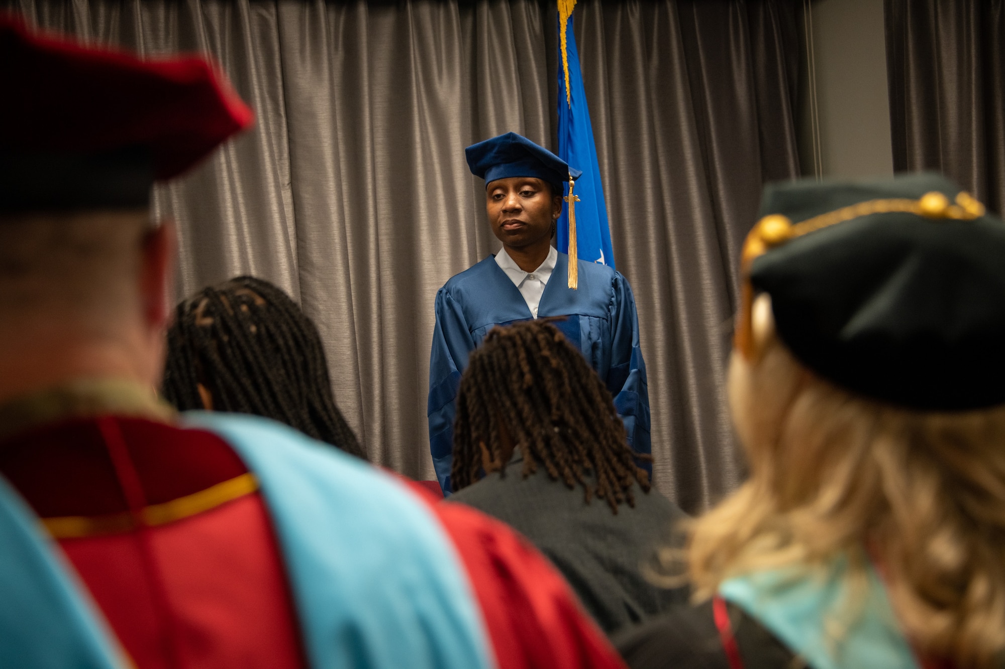 Senior Master Sgt. Anique S. McElveen waits to receive her doctoral hood during a ceremony at the Enlisted Heritage Hall on Maxwell Air Force Base, Gunter Annex, March 10, 2023.  She is part of just .007 percent of enlisted Airmen to receive a doctoral degree. McElveen is the superintendent of the College of Academic Management at the Community College of the Air Force. (U.S. Air Force photo/Brian Ferguson)