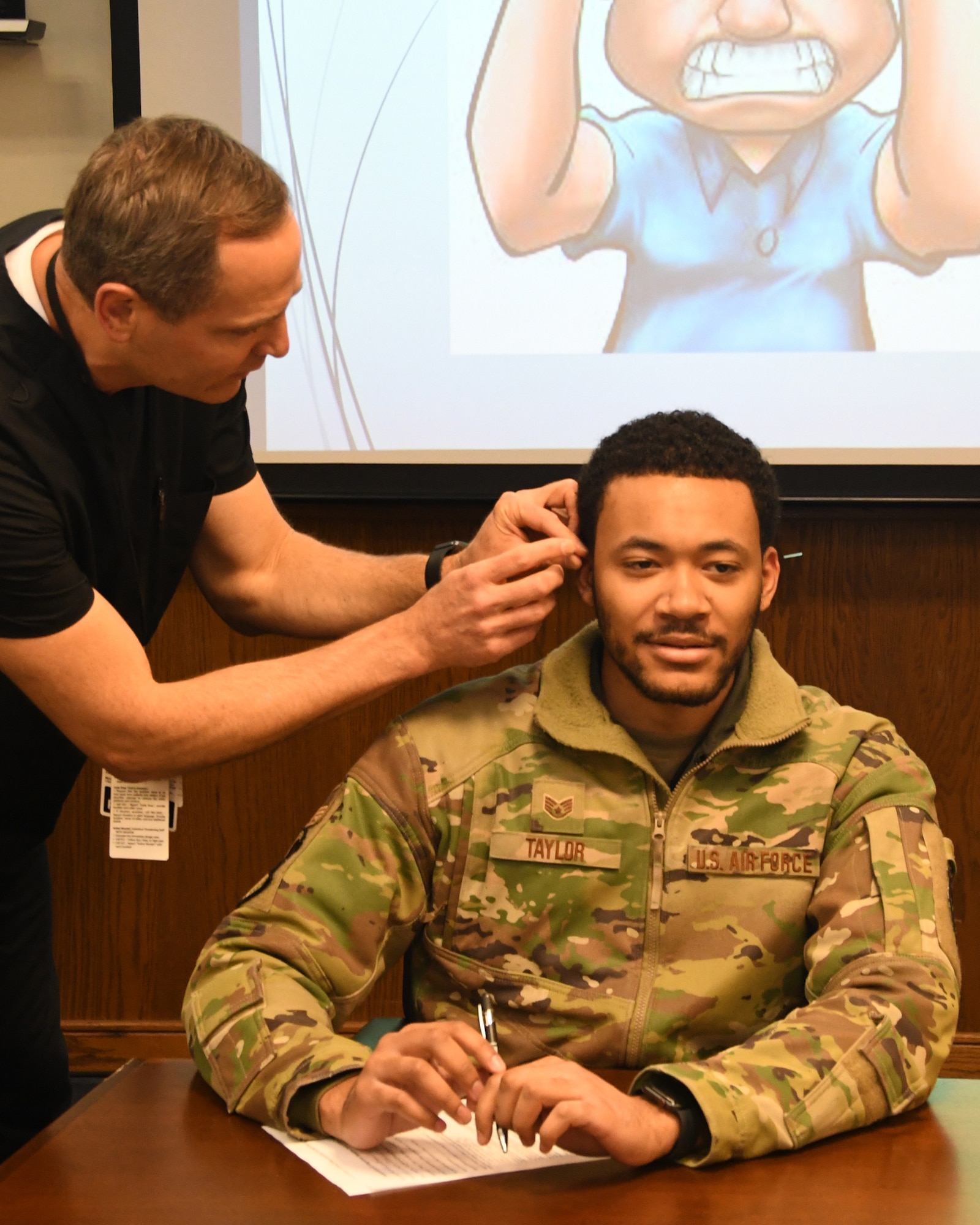 Staff Sgt. Brian Taylor, 756th Air Refueling Squadron, receives acupuncture needles during a free acupuncture session held at the 459th Air Refueling Wing headquarters building at Joint Base Andrews, Md., March 8, 2023. The acupuncturist was brought to the unit by the 459th Military and Family Readiness Office.