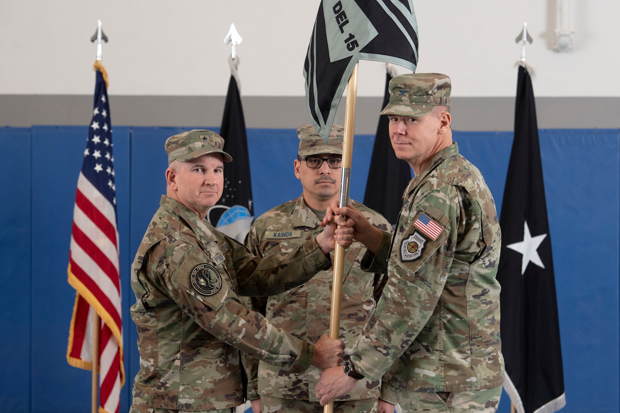 From left, U.S. Space Force Brig. Gen. Dennis Bythewood, Joint Task Force-Space Defense commander, U.S. Space Force Senior Master Sgt. Kristopher-Michael K. Kainoa, Space Delta 15 senior enlisted leader, and U.S. Space Force Col. Stephen Lyon, Space Delta 15 commander, participate in the passing of the guidon during the DEL 15 activation ceremony at Schriever Space Force Base, Colorado, March 10, 2023. The mission of DEL 15 is to provide service command-and-control (C2) capability, mission ready crew forces, skills training, certifications, intelligence, surveillance, and reconnaissance (ISR), and support and cyber mission defense, and special mission support to the JTF-SD and its National Space Defense Center. (U.S. Space Force photo by Dennis Rogers)