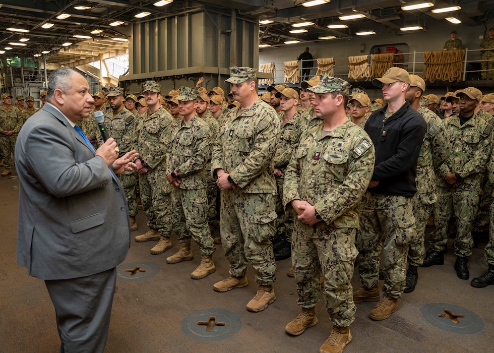 Secretary of the Navy Carlos Del Toro speaks with Sailors during an all-hands call aboard the Harpers Ferry-class dock landing ship USS Carter Hall (LSD 50), at Joint Expeditionary Base Little Creek-Fort Story, March 10, 2023.