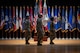 four people wearing u.s. army uniform stand in a group on a stage.