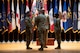 four people wearing u.s. army uniform stand in a group on a stage.