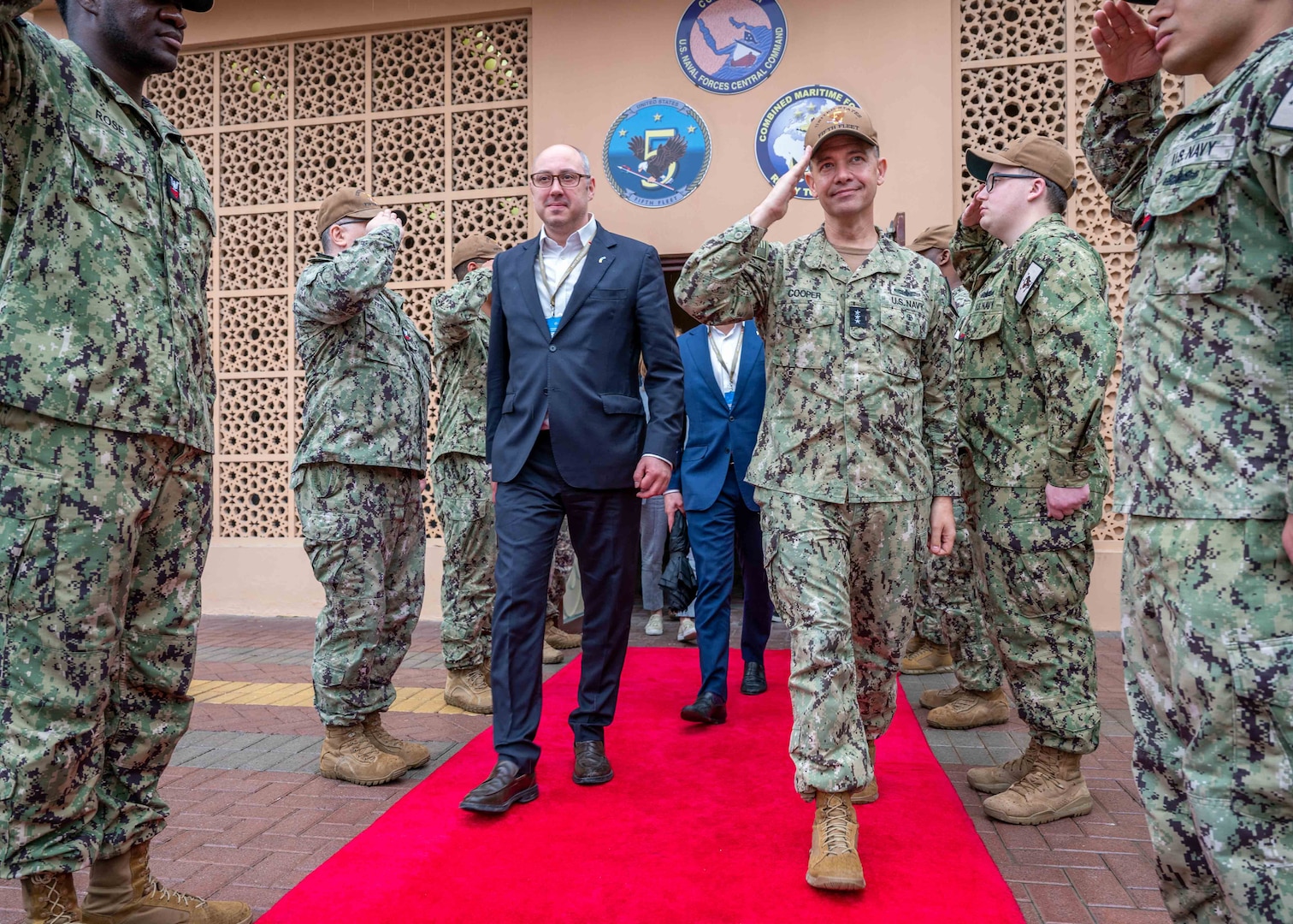 MANAMA, Bahrain (March 13, 2023) Vice Adm. Brad Cooper, commander of U.S. Naval Forces Central Command, U.S. 5th Fleet and Combined Maritime Forces, salutes as he departs  the U.S. Navy’s regional headquarters in Manama, Bahrain, with Ambassador of Ukraine to the United Arab Emirates Dmytro Senik on March 13, 2023.
