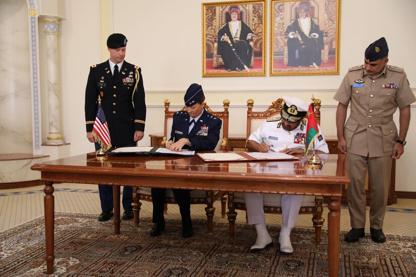 Maj. Gen. Kerry Muehlenbeck, commander of the Arizona National Guard, seated at left, signs an official partnership decree with Vice Admiral Abdullah bin Khamis Al-Raisi, chief of staff of the Sultan's Armed Forces, during a ceremony in Muscat, Oman, solidifying Oman as a partner with the state of Arizona under the State Partnership Program. The SPP links a state’s National Guard with armed forces of a partner country in a cooperative, mutually beneficial relationship.