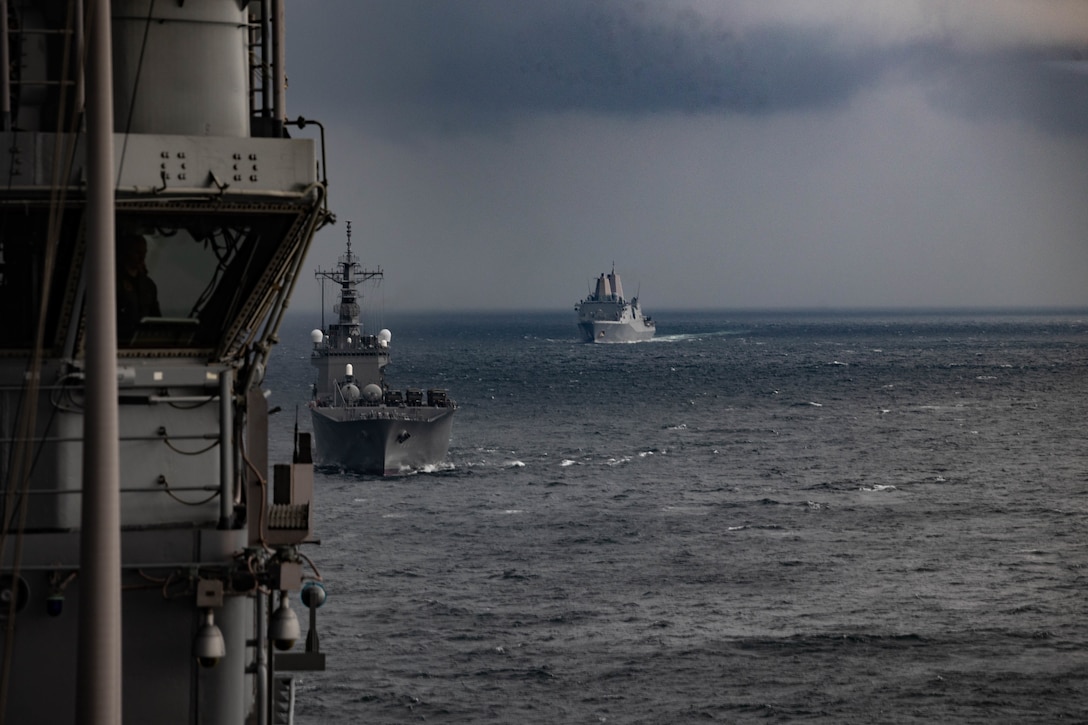 The U.S. Navy’s amphibious transport dock ship USS Green Bay (LPD-20) with the 31st Marine Expeditionary Unit, right, and the Japan Maritime Self-Defense Force’s tank landing ship JS Osumi (LST-4001), center, move in formation behind the amphibious assault ship USS America (LHA-6) during Iron Fist 23 in the Philippine Sea Mar. 1, 2023. Iron Fist 23 provided an opportunity for ships of the USS America Amphibious Ready Group and the JMSDF to work together in coordinating large scale ship operations. Iron Fist is an annual bilateral exercise designed to increase interoperability and strengthen the relationships between the U.S. Marine Corps, the U.S. Navy, the Japan Ground Self-Defense Force, and the JMSDF. (U.S. Marine Corps photo by Lance Cpl. William N. Wallace)