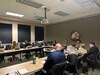 People sitting at a conference table in a meeting.