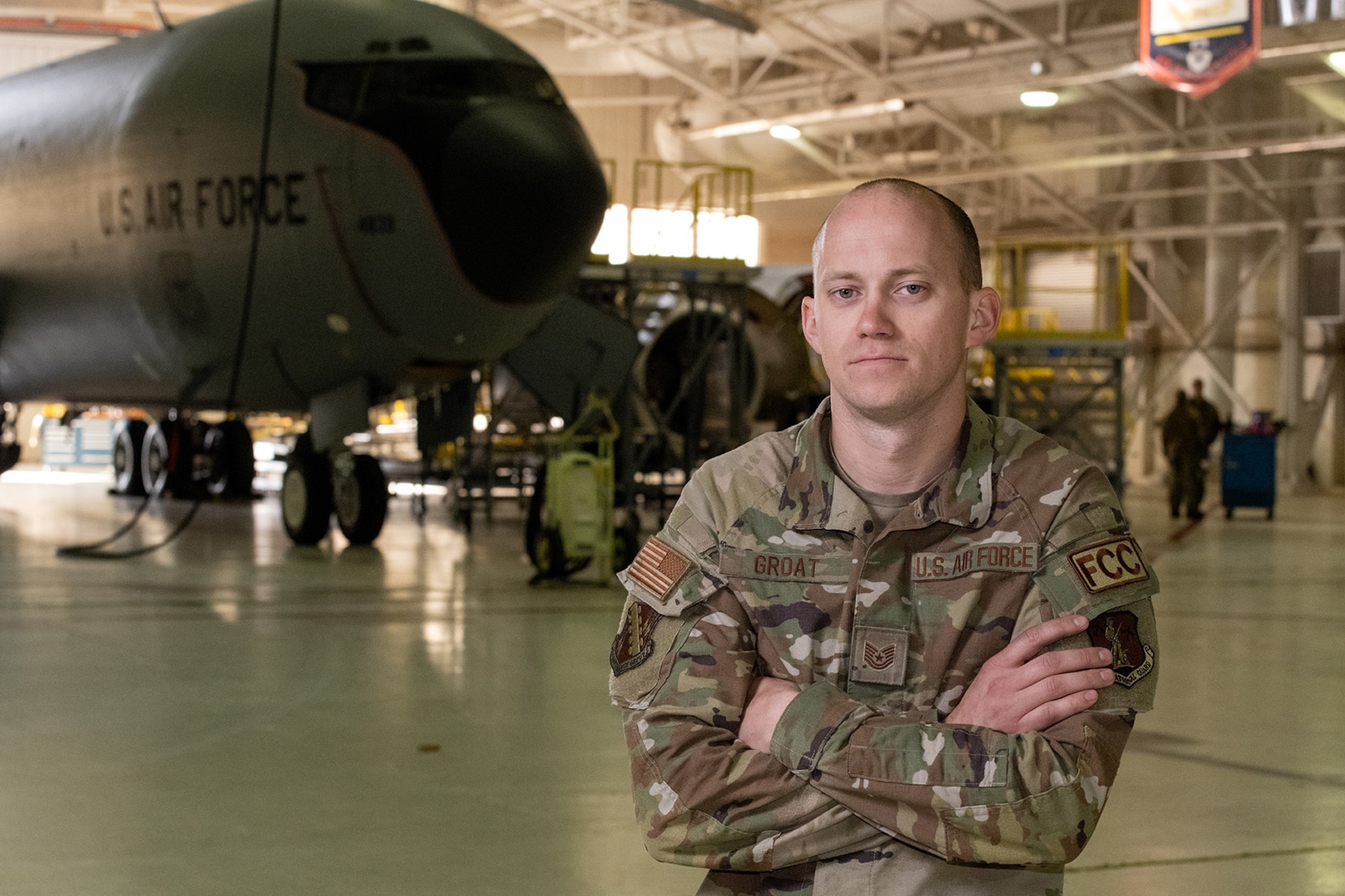 A U.S. Air Force member is shown in uniform in front of a KC-135.