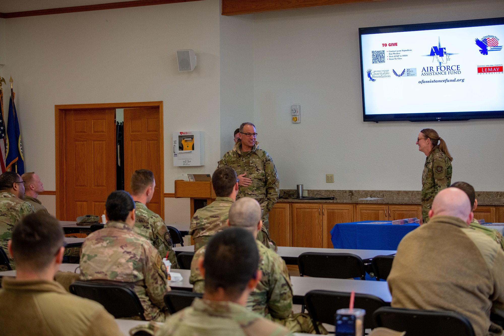 Col. Nate Vogel (center), commander of the 22nd Air Refueling Wing, speaks with McConnell Airmen about donating to the Air Force Assistance Fund at McConnell Air Force Base, Kansas, Mar. 13, 2023. The Air Force Assistance Fund is an annual fund-raising campaign for charities that support Air Force families in need, retired veterans and widowed spouses. The four charities are the Air Force Aid Society, the Air Force Enlisted Village, the LeMay Foundation, and the Air Force Villages Charitable Foundation. (U.S. Air Force Photo by Airman Gavin Hameed)