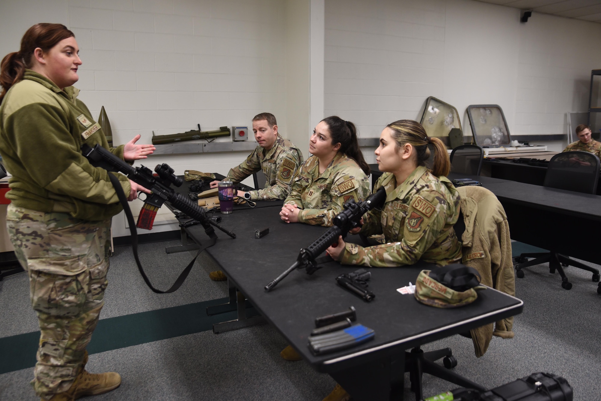U.S. Air Force Senior Airman Lindsay Francher, combat arms instructor with the 627th Security Forces Squadron, teaches Airmen how to handle a weapon during weapons qualification training at Joint Base Lewis-McChord, Washington, March 9, 2023. Weapons qualifications trainings are held to ensure service members are deployment ready. (U.S. Air Force photo by Airman Kylee Tyus)