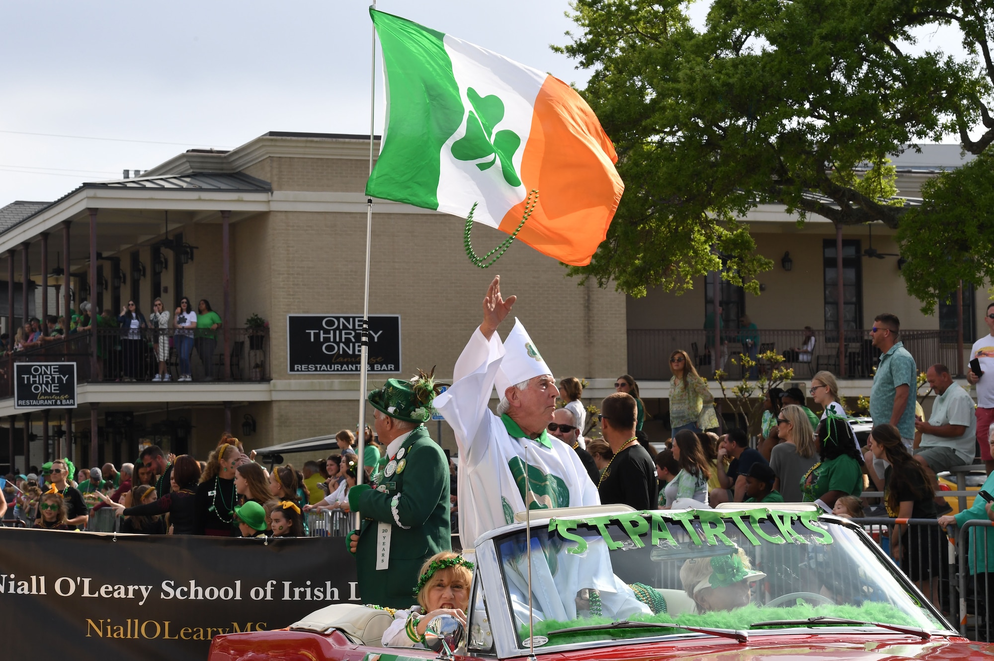 Quin Gautier, 2023 St. Patrick, tosses beads during the Hibernia Marching Society of Mississippi St. Patrick's Day Parade in Biloxi, Mississippi, March 11, 2023.