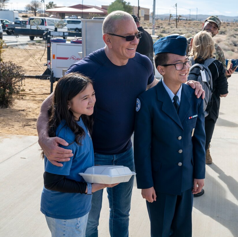 Celebrity Chef Robert Irvine takes a photo with Edwards JROTC cadets during the Breaking Bread for Heroes event at Edwards Air Force Base, California, March 10.