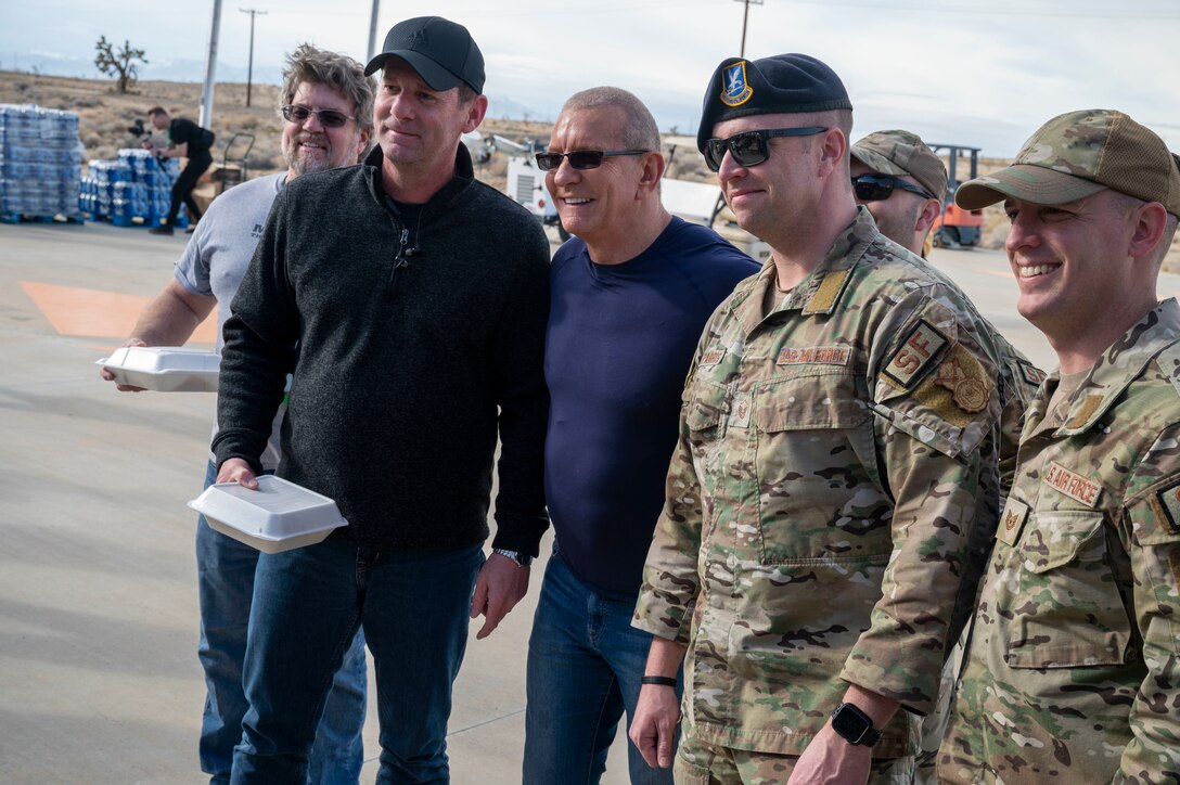 Celebrity Chef Robert Irvine takes a photo with base personnel during the Breaking Bread for Heroes event at Edwards Air Force Base, California, March 10.