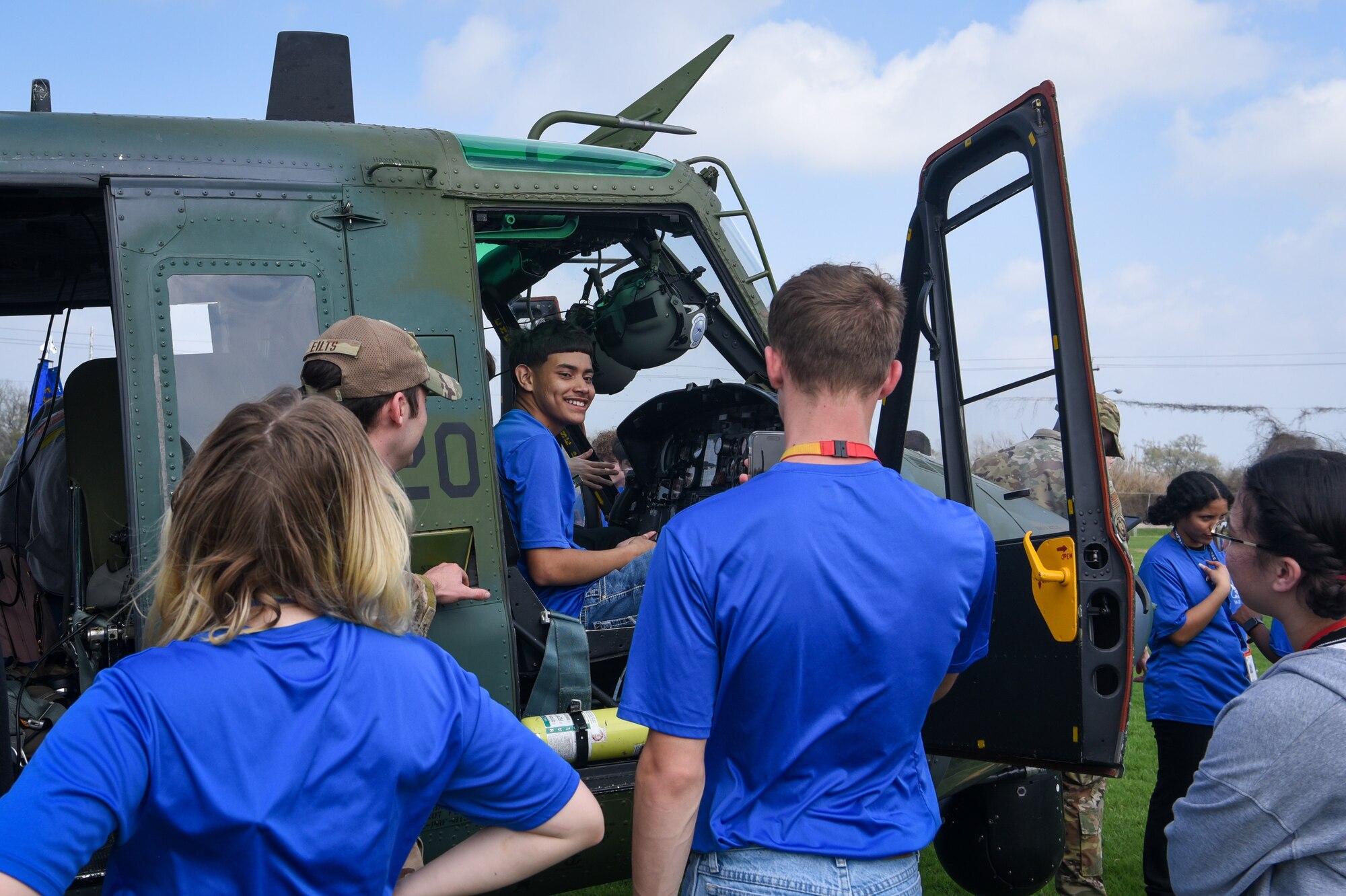 students in and around helicopter