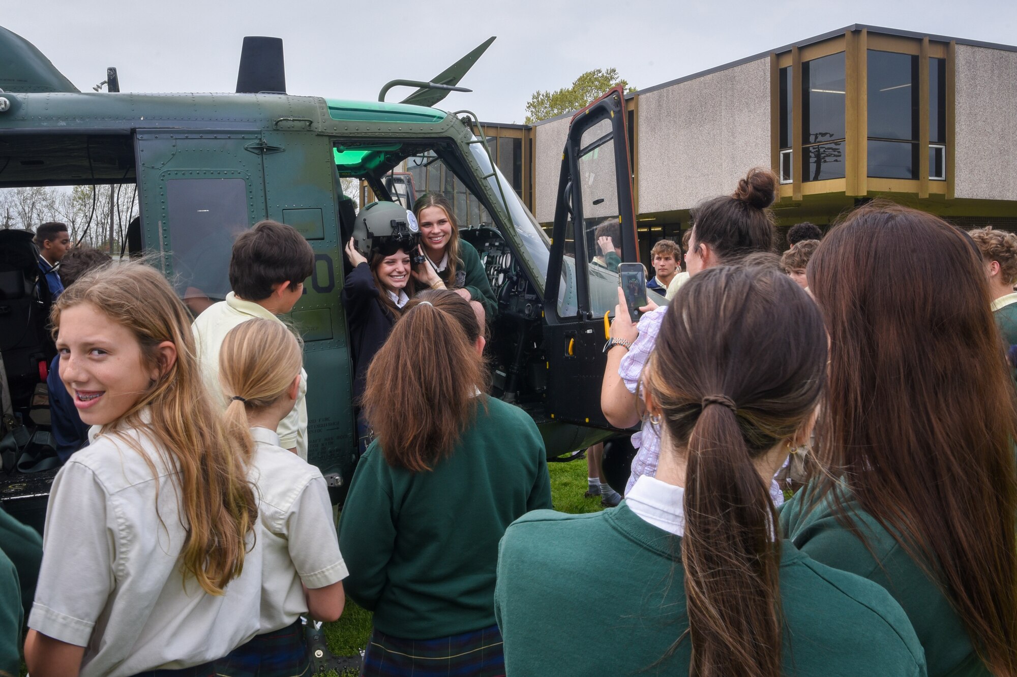 students in and around helicopter