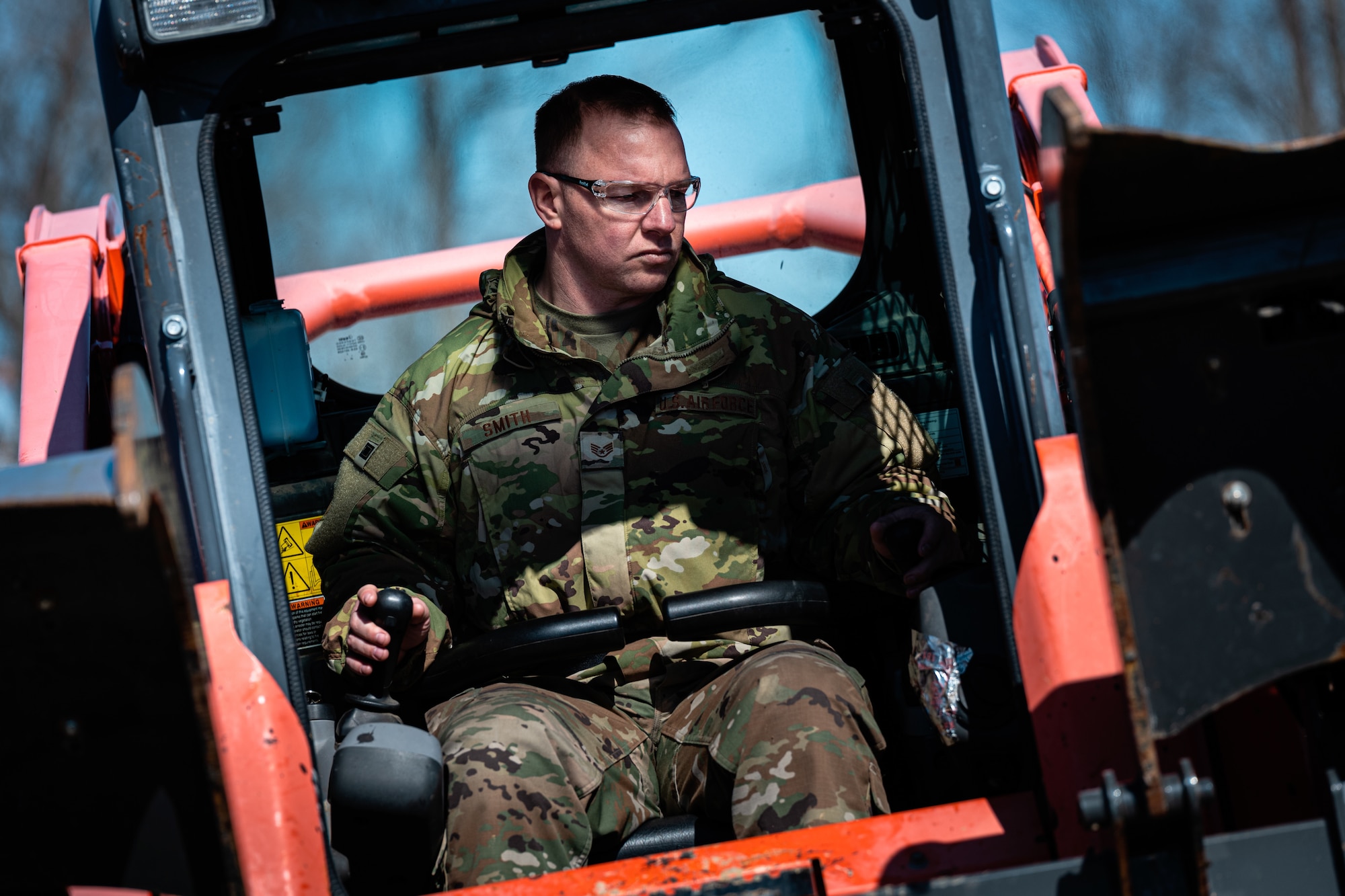 Air Force Staff Sgt. Daniel Smith, an Airman with the 181st Civil Engineer Squadron, operates heavy machinery during a route-clearing exercise at Camp Atterbury Joint Maneuver Training Center in Edinburgh, Ind., March 4, 2023. The 181st CES trained to promote cross-functional capabilities.