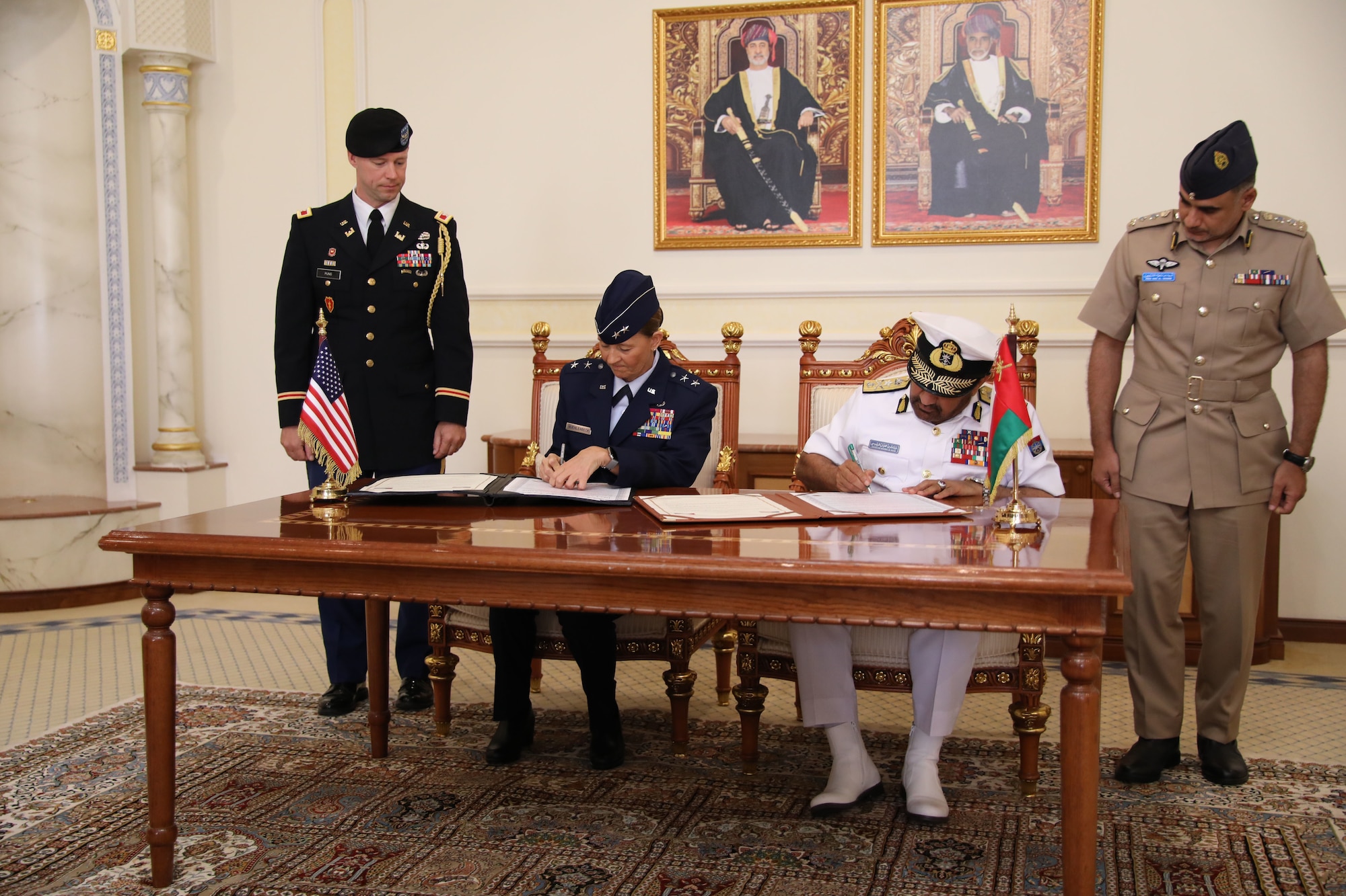 Maj. Gen. Kerry Muehlenbeck, commander of the Arizona National Guard, seated at left, signs an official partnership decree with Vice Admiral Abdullah bin Khamis Al-Raisi, chief of staff of the Sultan's Armed Forces, during a ceremony in Muscat, Oman, solidifying Oman as a partner with the state of Arizona under the State Partnership Program. The SPP links a state’s National Guard with armed forces of a partner country in a cooperative, mutually beneficial relationship.