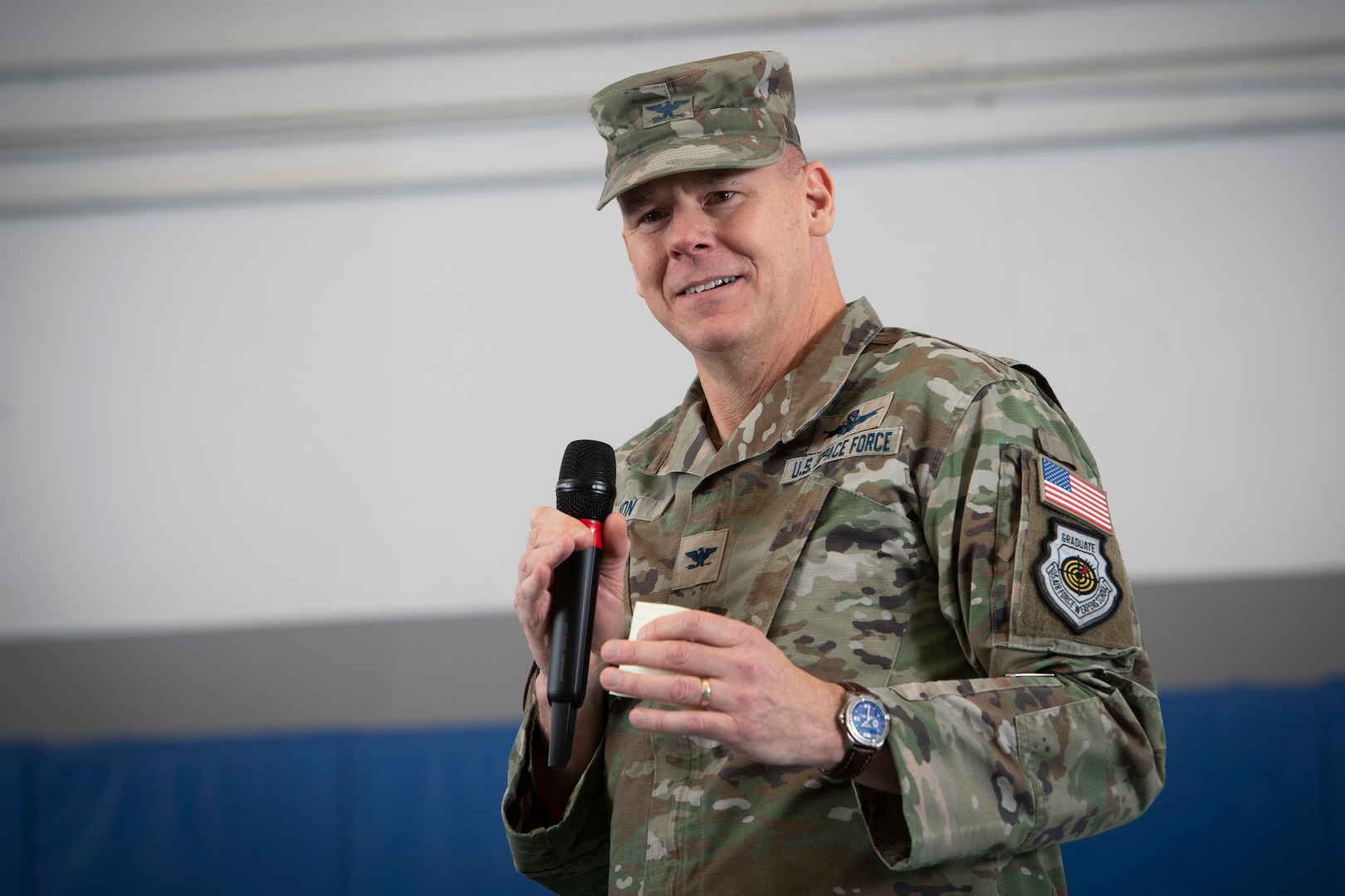 Man in uniform speaking into microphone