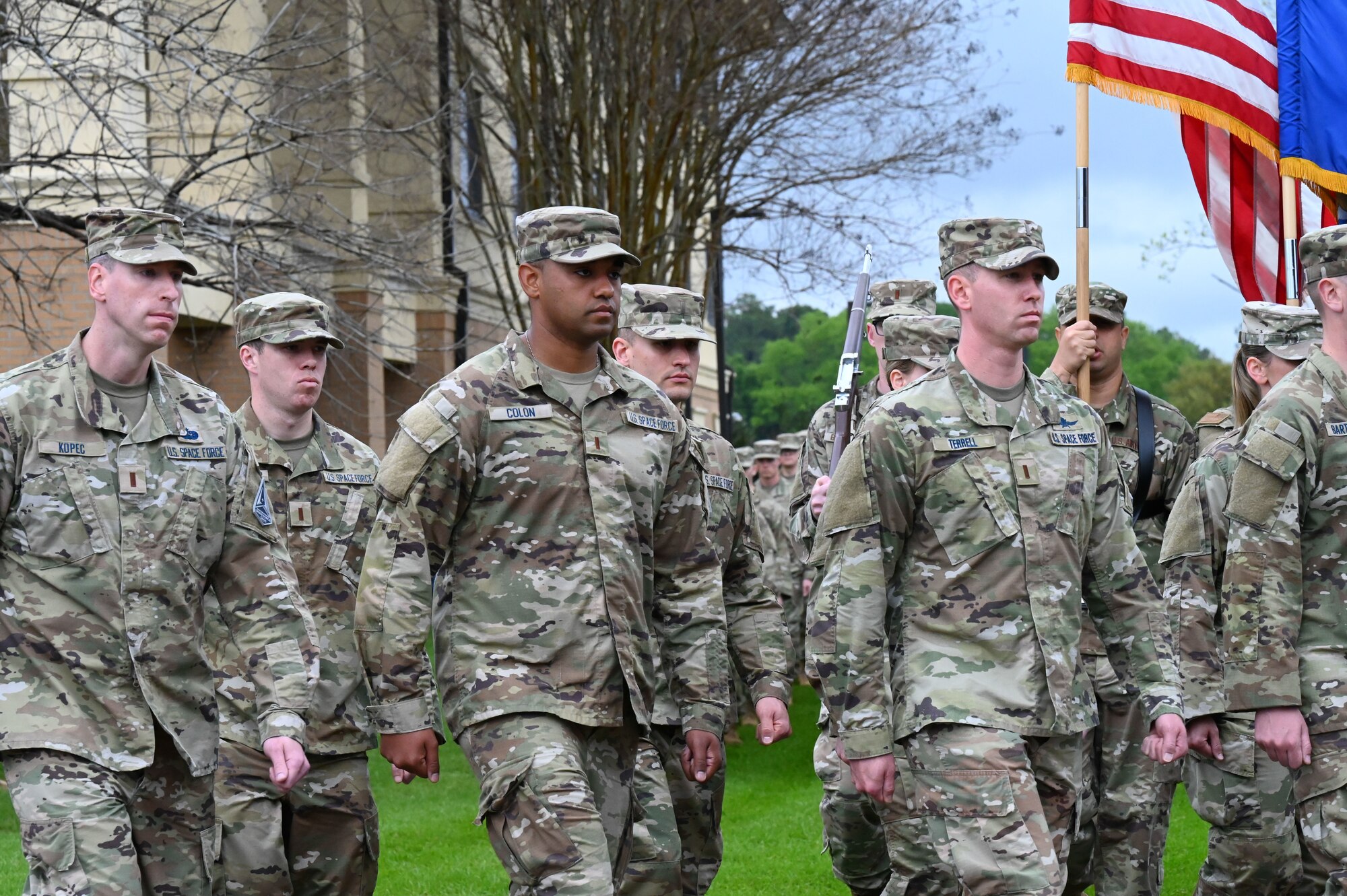 U.S. Space Force Guardians march by for pass and review at Officer Training School, March 10, 2023, at Welch Field, Maxwell Air Force Base, Alabama. The officers comprised the first all-Space Force flight to commission from OTS.