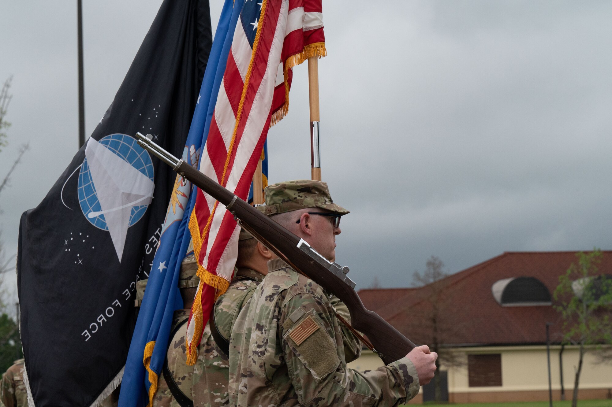 Guidon bearers from Officer Training School march during pass and review March 10, 2023, at Welch Field, Maxwell Air Force Base, Alabama. The school graduated and commissioned its first all-Space Force flight, comprised of 15 officers heading to be leaders in the newly created force.