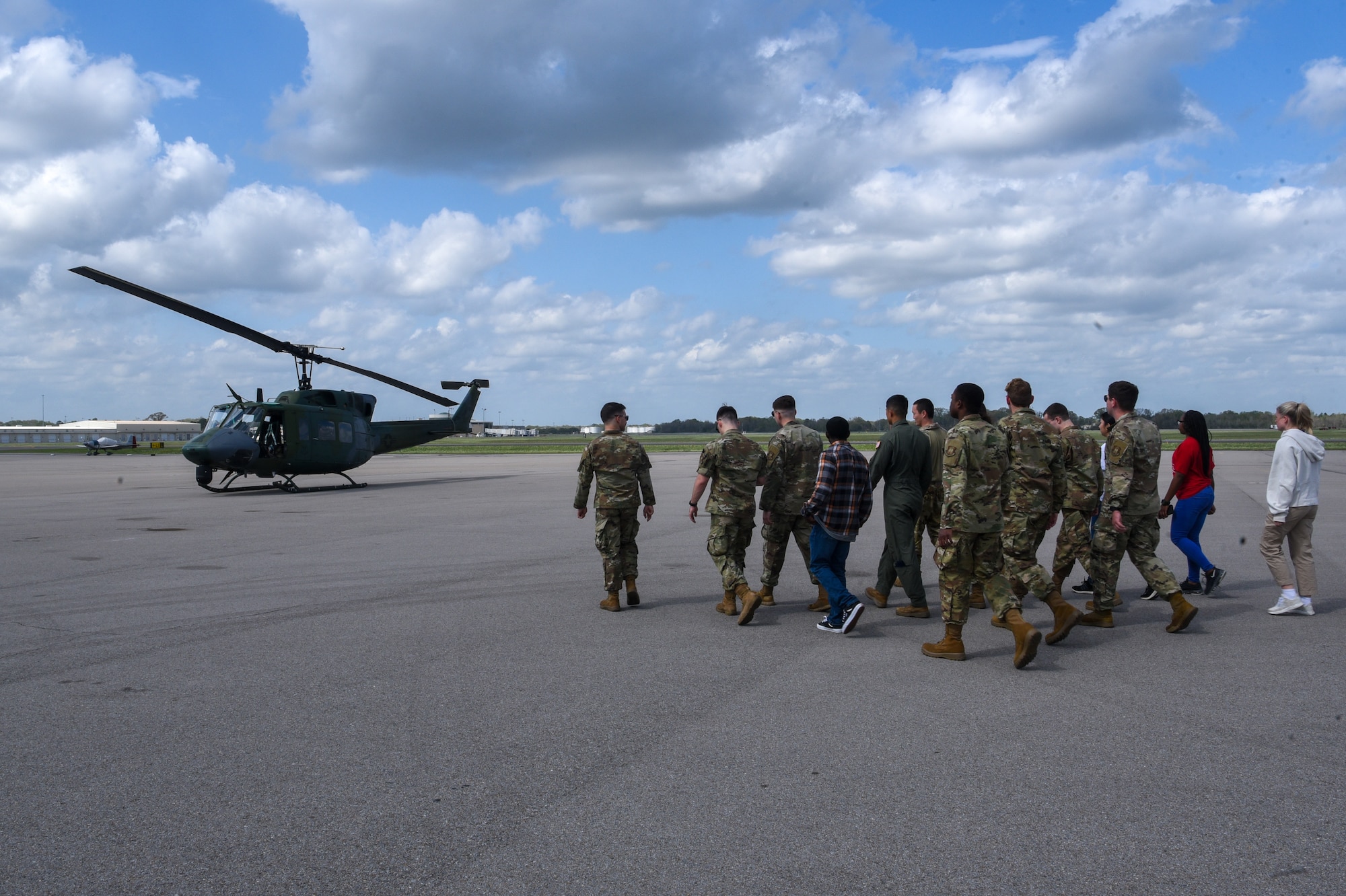 group of ROTC cadets walk to helicopter