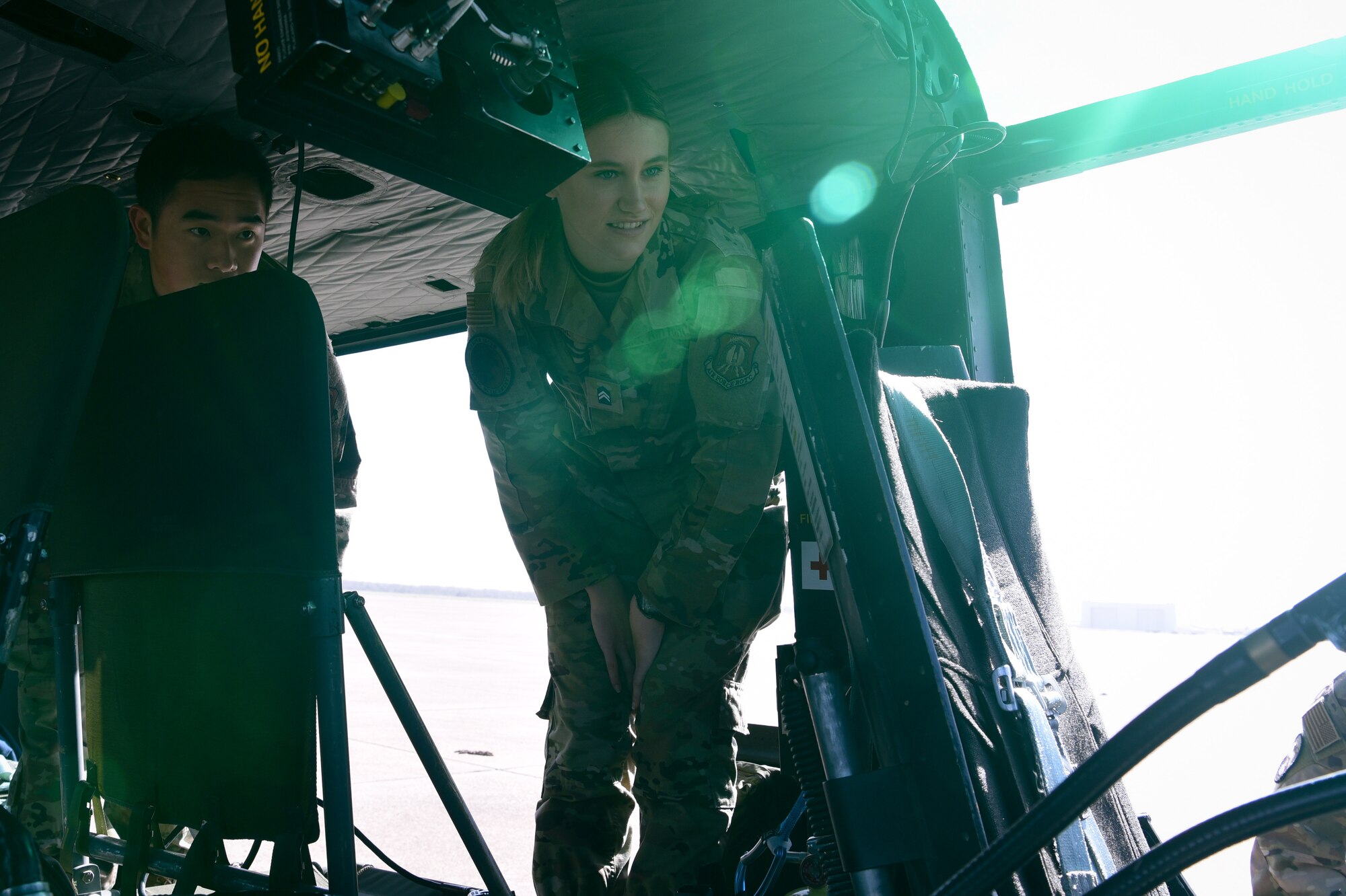 two ROTC cadets look in cockpit of helicopter