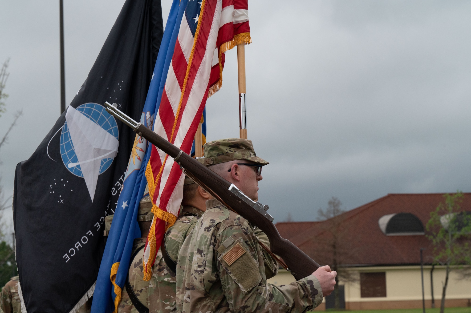 Guidon bearers from Officer Training School march during pass and review March 10, 2023, at Welch Field, Maxwell Air Force Base, Alabama. The school graduated and commissioned its first all-Space Force flight, comprised of 15 officers heading to be leaders in the newly created force.