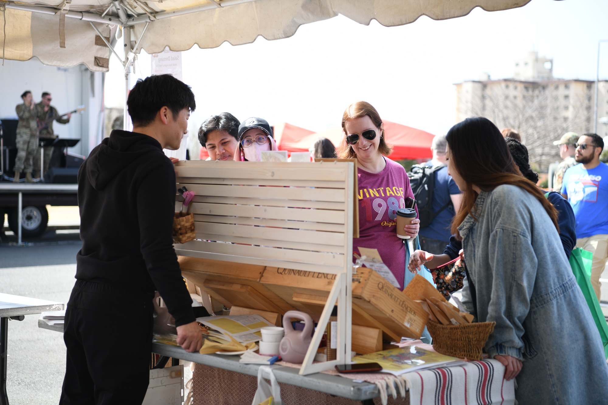 A Japanese man speaks with three women.