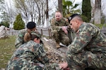 Sgt. Thomas Marvin of HHC, 2nd Battalion, 113th Infantry Regiment, 44th Infantry Brigade Combat Team, New Jersey Army National Guard, supervises tactical combat casualty care training scenarios with members of the Albanian Armed Forces at Land Forces Headquarters, Zall-Herr, Tirana, Albania, March 9, 2023, as part of the State Partnership Program. The New Jersey Guard sent more than 40 service members to collaborate with their subject-matter counterparts in the AAF.