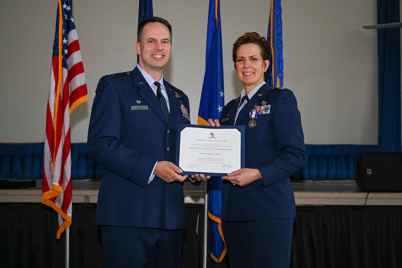 U.S. Air National Guard Col. Deane E. Thomey, 111th Attack Wing Commander, presents U.S. ANG Col. Christine E. Munch, 111th Mission Support Group Commander, with the Pennsylvania Distinguished Service Medal during her retirement ceremony held at Biddle Air National Guard Base in Horsham Pennsylvania, March 5, 2023. While serving as the 111th MSG Commander, Munch led a group made of seven units consisting of more than 600 personnel, before retiring at the base where she served more than 16 years of her military career. (U.S. Air National Guard Photo by Airman 1st Class Charles Casner)