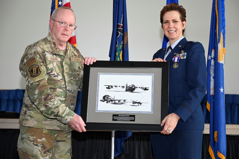 U.S. Air National Guard Brig. Gen. Michael J. Regan, Deputy Adjutant General–Air for the Commonwealth of Pennsylvania and Commander of the Pennsylvania Air National Guard, presents U.S. ANG Col. Christine E. Munch, 111th Mission Support Group Commander, with a framed photo during her retirement ceremony held at Biddle Air National Guard Base in Horsham Pennsylvania, March 5, 2023.  During the ceremony, Munch was recognized for her nearly 36 years of military service and was also presented a Pennsylvania Distinguished Service medal. (U.S. Air National Guard photo by Airman 1st Class Charles Casner)