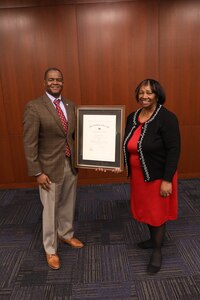 Naval Surface Warfare Center, Philadelphia Division Activity Security Manager Dorothy Morton is presented with a career service award for 50 years of government service by Technical Director Nigel C. Thijs during the NSWCPD Fiscal Year 2023 Quarterly Awards Ceremony on Feb. 27, 2023. (U.S. Navy photo by Sgt. Jermaine Sullivan/Released)