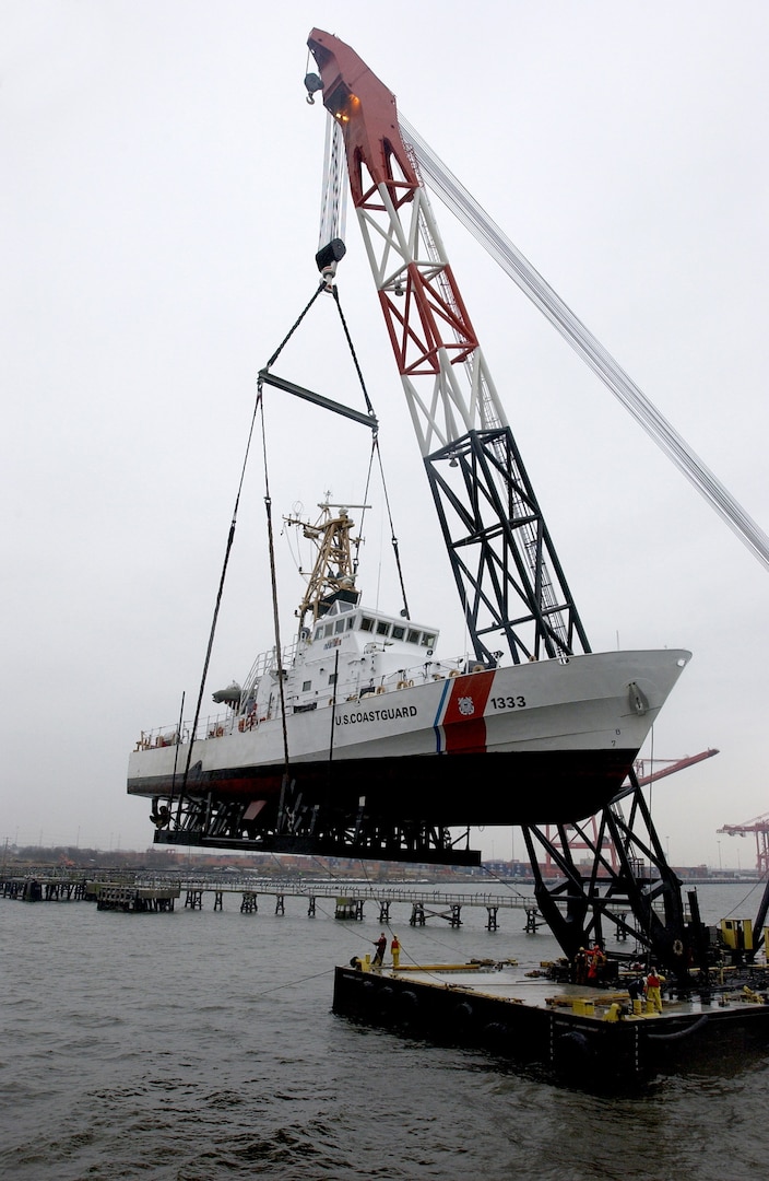 The Coast Guard Cutter Adak, from Sandy Hook, New Jersey, is loaded onto a military transport ship at the Norfolk International Terminal in Norfolk, Virginia, Jan. 29, 2003. Crew members will meet their cutters overseas as they deploy in support of the war on terrorism.