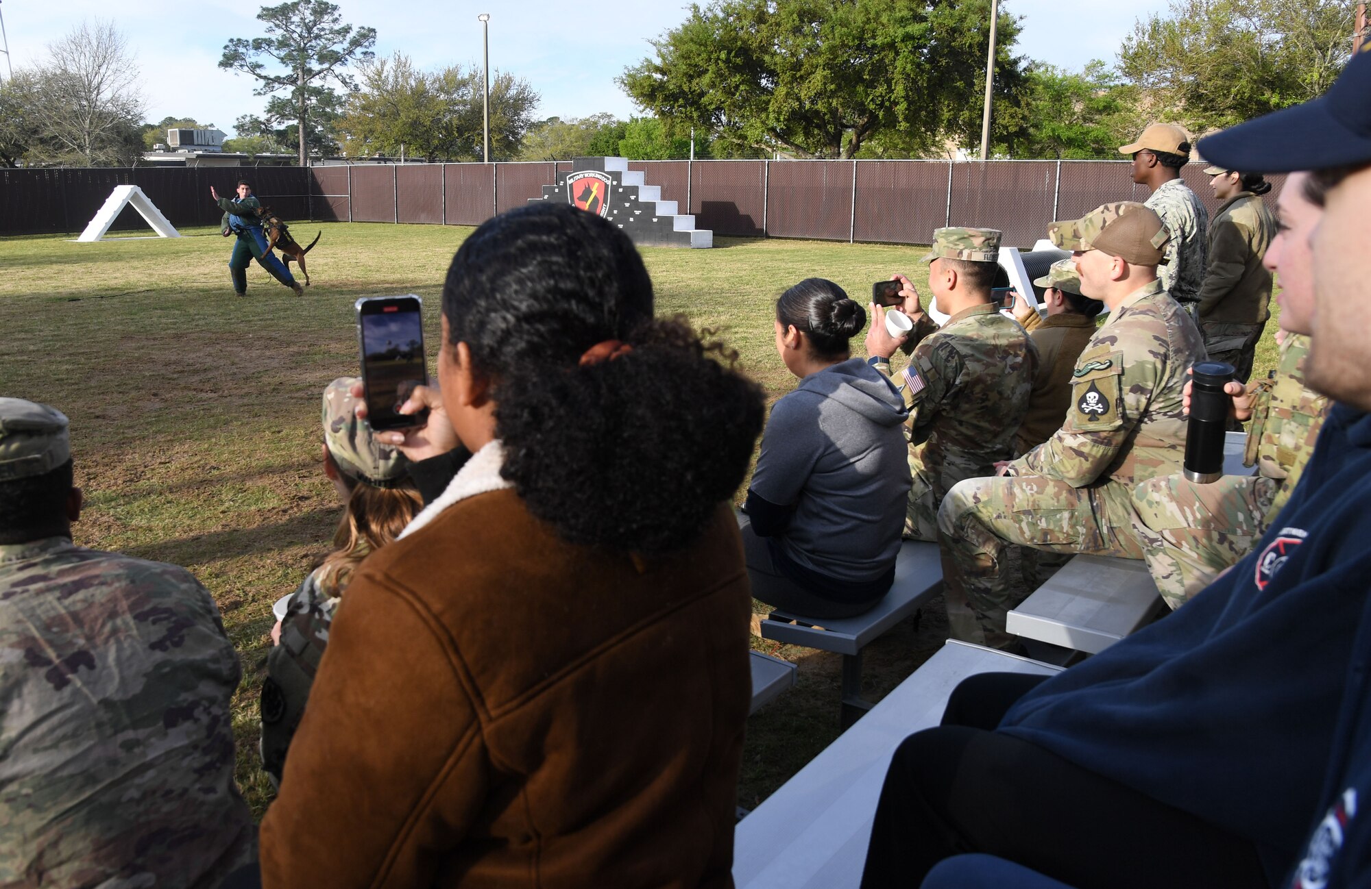 U.S. Air Force Staff Sgt. Anthony Seretis, 81st Security Forces Squadron military working dog handler, and Kkorvette, Naval Construction Battalion Center Gulfport military working dog, participate in a demonstration during the K-9 Veteran's Day Ruck & Demonstration at Keesler Air Force Base, Mississippi, March 13, 2023.