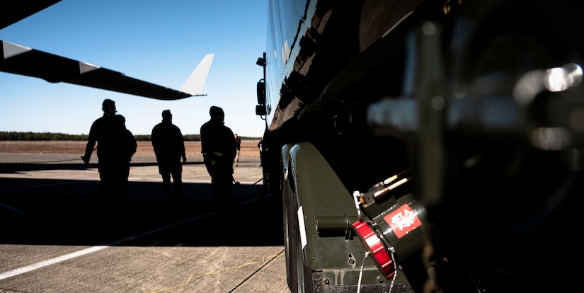 Airmen assigned to the 305th Air Mobility Wing and 87th Logistics Readiness Squadron fuels management flight prepare a R-11 fuel truck to perform a wet-wing defuel with a C-17 Globemaster during exercise White Stag at Joint Base McGuire-Dix-Lakehurst, N.J., Mar. 9. 2023.