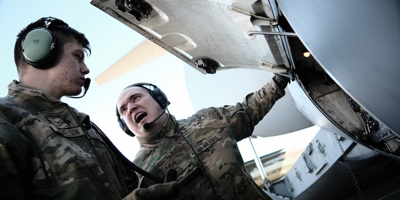 U.S. Air Force Staff Sgt. Eric Jones and Airman 1st Class Jesse Harrelson, 6th Airlift Squadron loadmasters, perform a wet-wing defuel of a C-17 Globemaster during exercise White Stag on Joint Base McGuire-Dix-Lakehurst, N.J., Mar. 9, 2023.