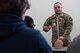 Male Soldier demonstrates first aid to high school students.