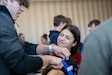 Joseph Alu, a student at Central York High School in York, Pennsylvania, practices applying a tourniquet on fellow student Evangelia Barakos during 