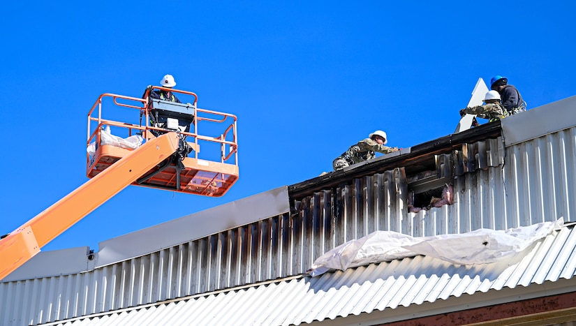 Airmen clear equipment from building 777 after a structural fire.