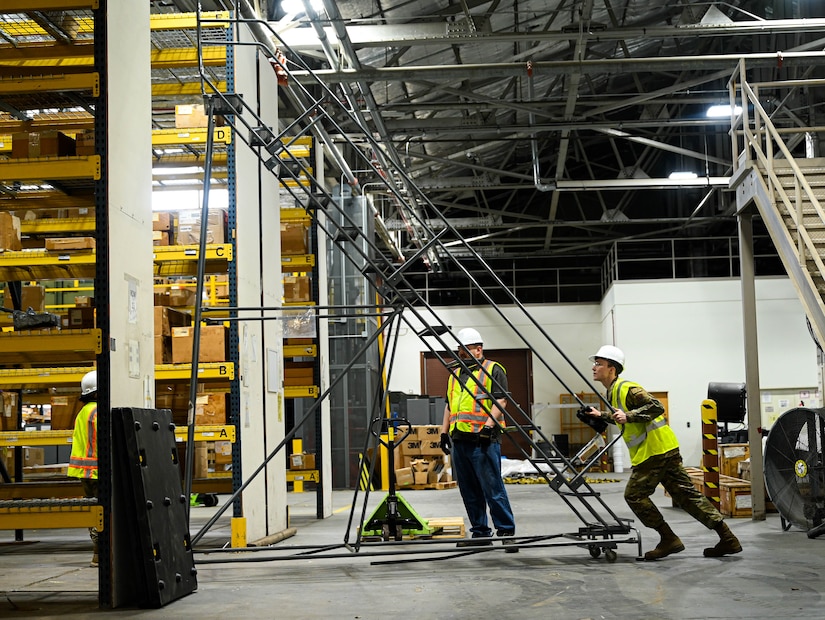 Airmen clear equipment from building 777 after a structural fire.