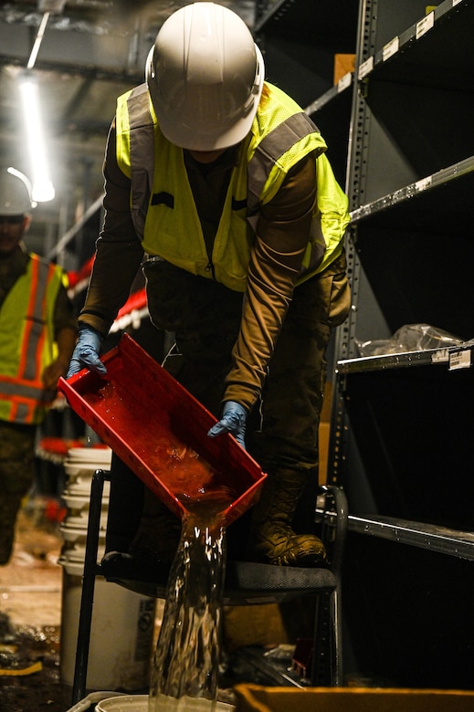 Airmen clear equipment from building 777 after a structural fire.