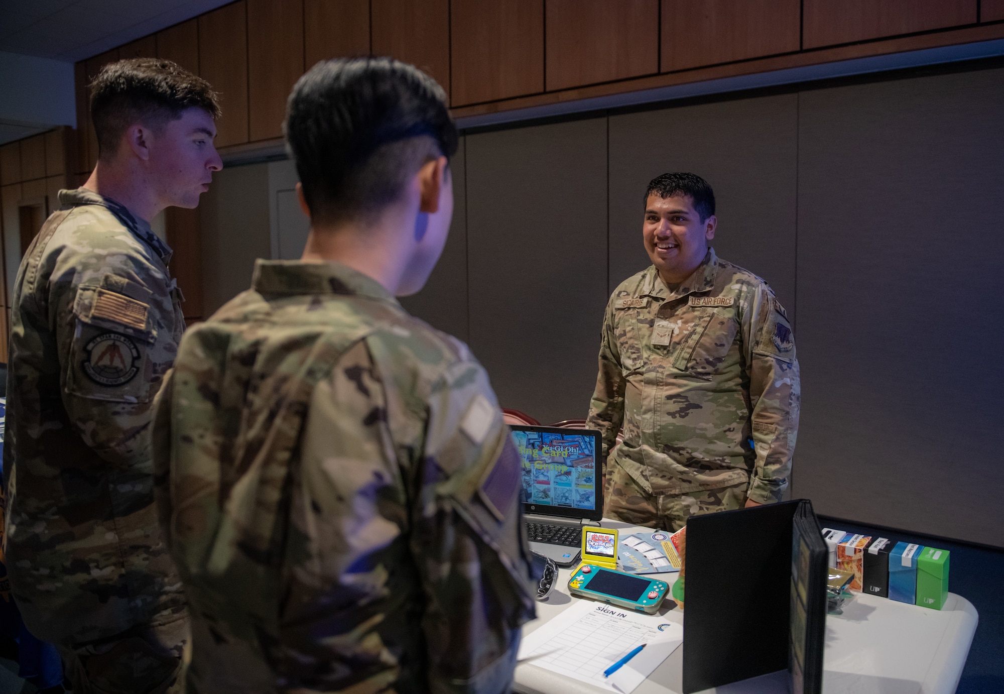 Airman stand around a table