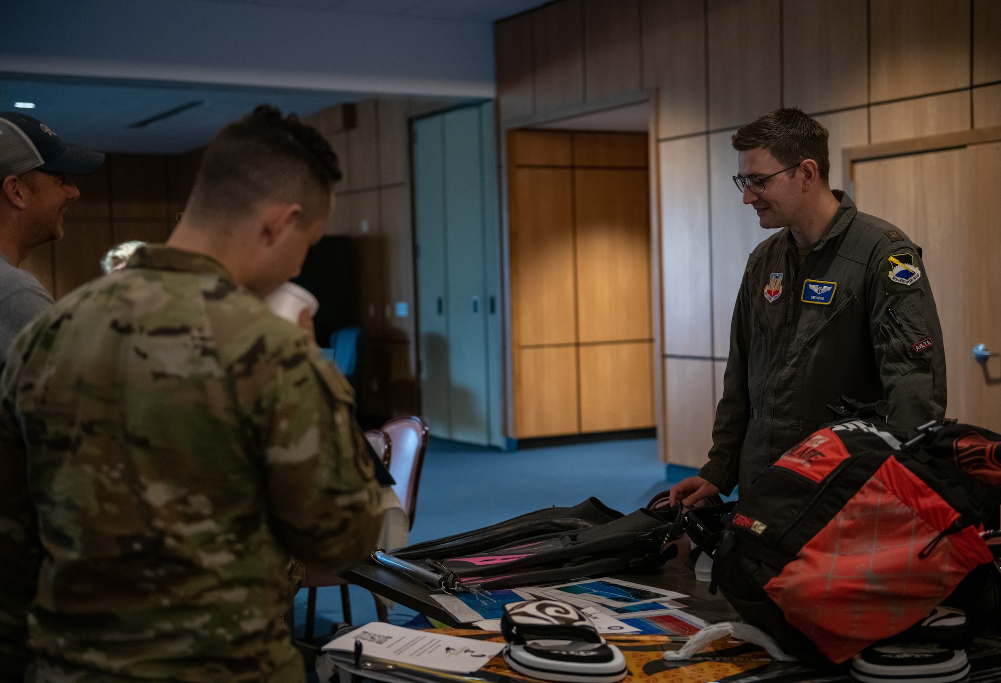 Airman stand around a table