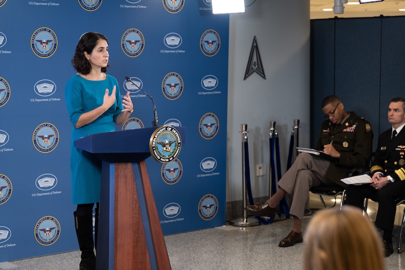 A woman speaks to reporters.