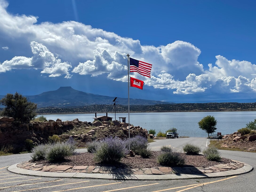 ABIQUIU LAKE, N.M. – The American and USACE flags fly at the Abiquiu Lake boat ramp as monsoons build up over Cerro Pedernal, Oct. 8, 2022. Photo by Brady Dunne. This photo tied for third place based on employee voting.